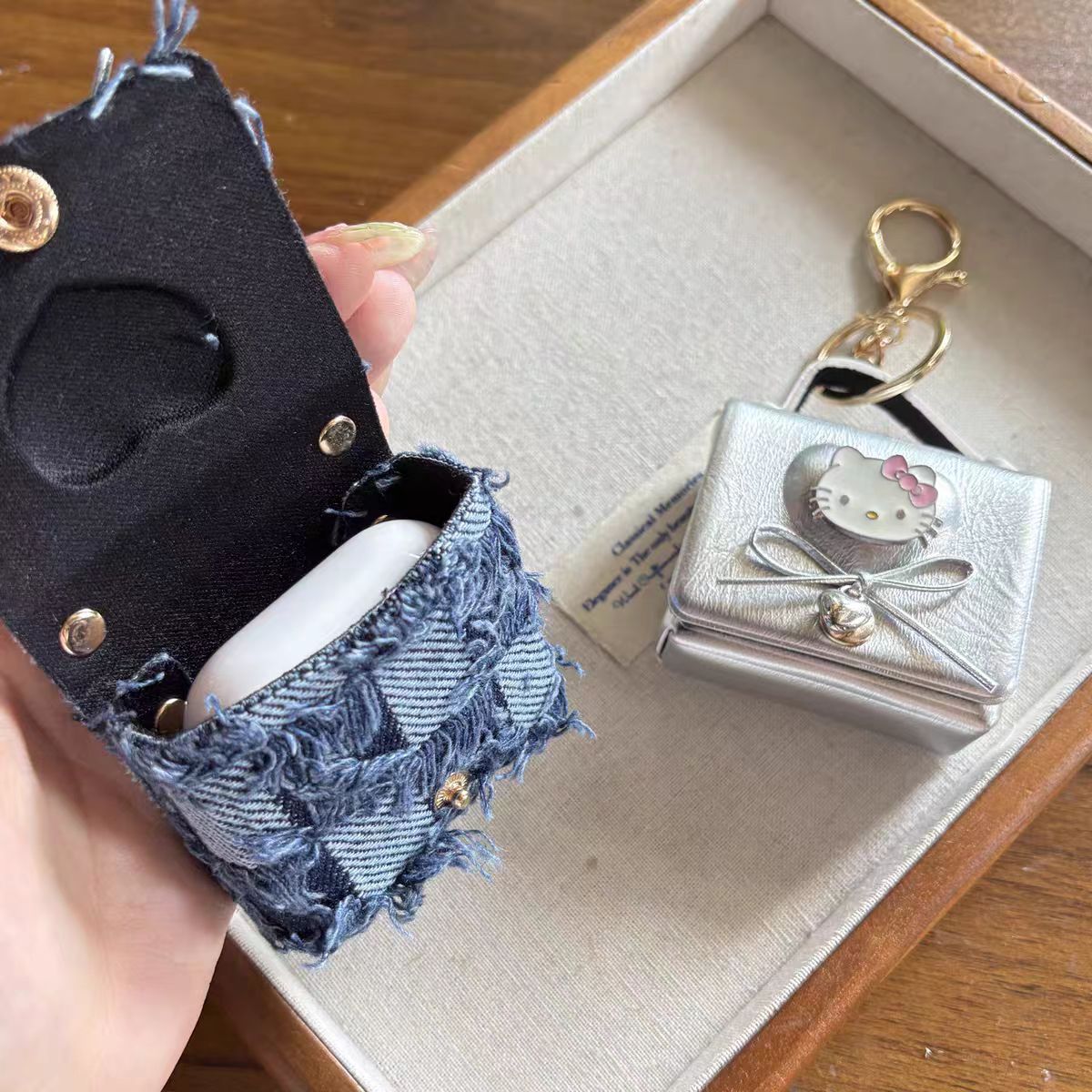 Hello Kitty AirPods Case Keychain – Denim Patchwork & Metallic Silver Protective Cover with Cute Bow & Bell Charm